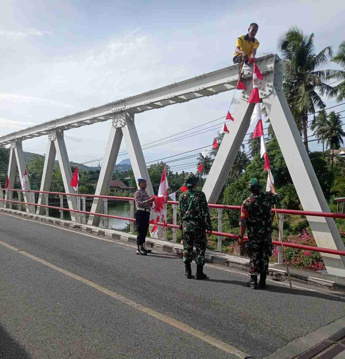 Bersama TNI dan Masyarakat, Polsek Mesjid Raya Hiasi Jembatan dengan Bendera Merah Putih